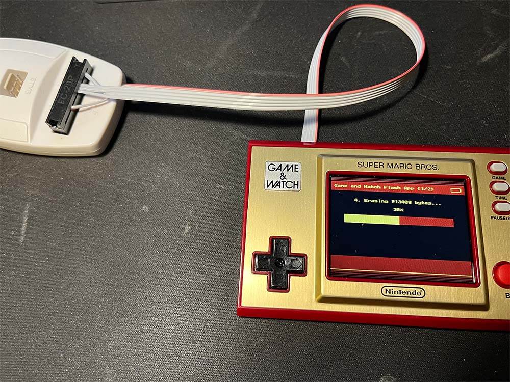 The Game and Watch is showing progress display as Retro Go is being installed